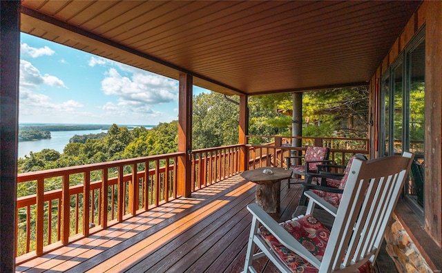 wooden deck featuring a water view