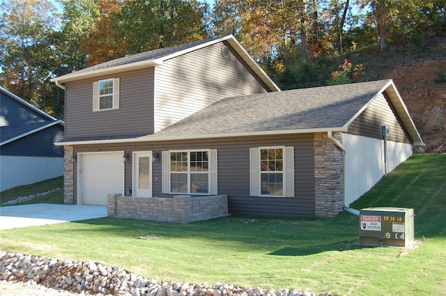 view of front of home with a front lawn and a garage