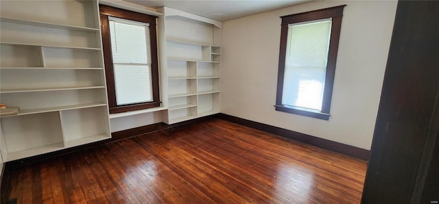 spare room featuring dark wood-type flooring