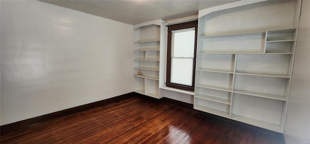 spare room featuring dark wood-type flooring