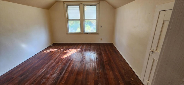 bonus room featuring lofted ceiling and dark hardwood / wood-style floors