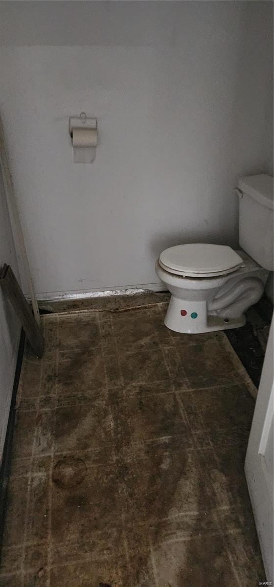 bathroom with tile flooring and toilet