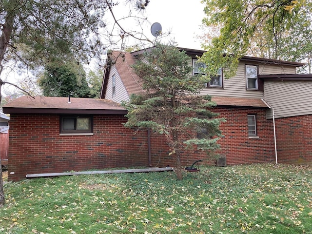 view of property exterior with a lawn