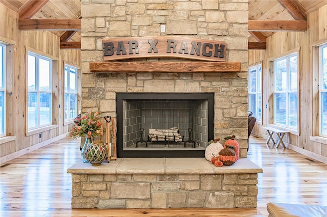 interior details with beamed ceiling, a fireplace, and hardwood / wood-style flooring