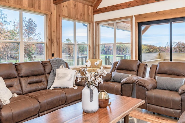 living room featuring wood walls, lofted ceiling, and hardwood / wood-style floors