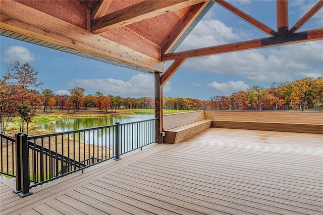 wooden terrace featuring a water view