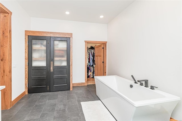 bathroom with tile patterned flooring and a bathing tub