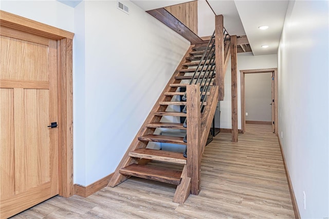 stairs with light wood-type flooring