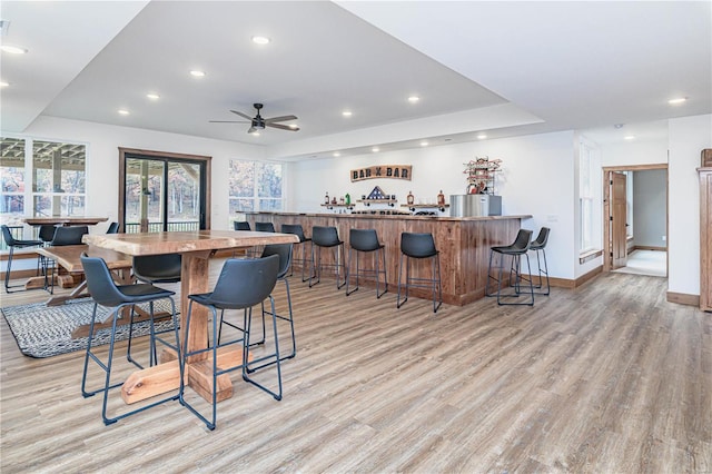 dining room featuring light hardwood / wood-style floors, ceiling fan, and plenty of natural light