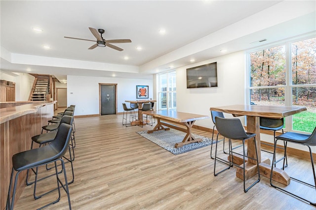 living room with light wood-type flooring and ceiling fan