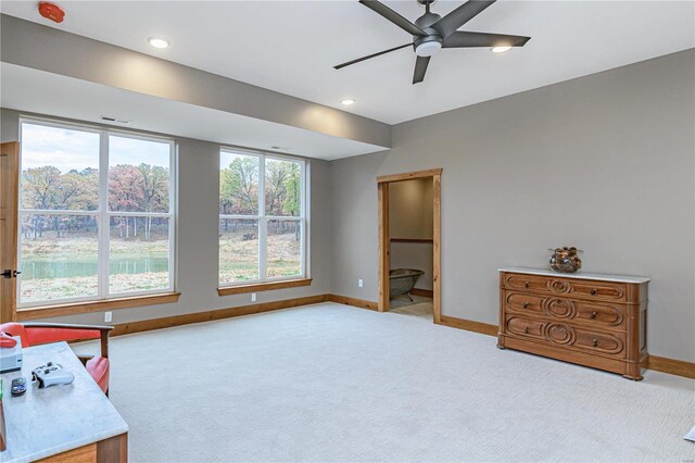 interior space with carpet flooring and ceiling fan