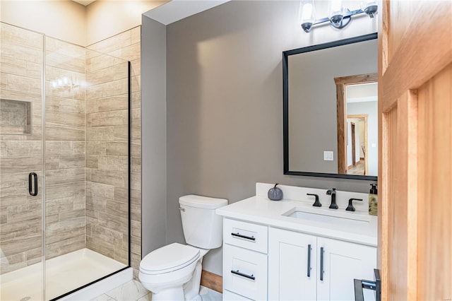 bathroom featuring a shower with door, vanity, tile patterned flooring, and toilet