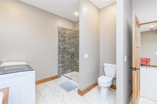 bathroom with vanity, an enclosed shower, toilet, washer / clothes dryer, and tile patterned flooring