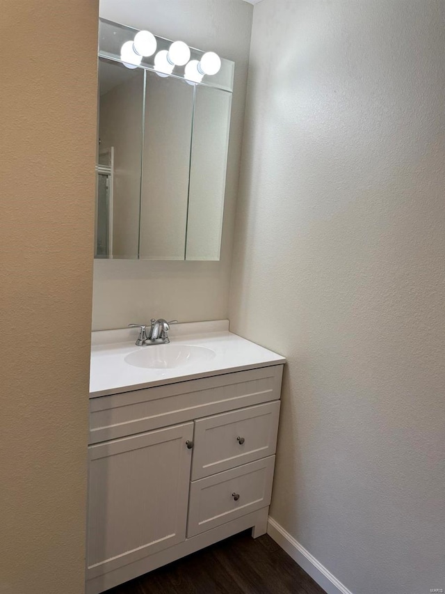 bathroom with vanity and wood-type flooring