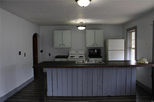 kitchen with a center island, white cabinetry, white appliances, and sink