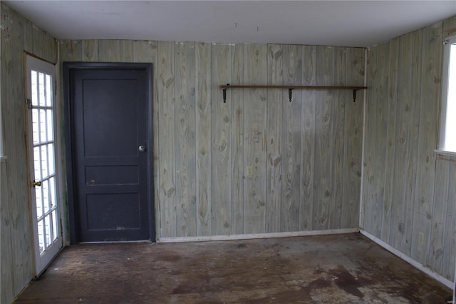 spare room with wood walls