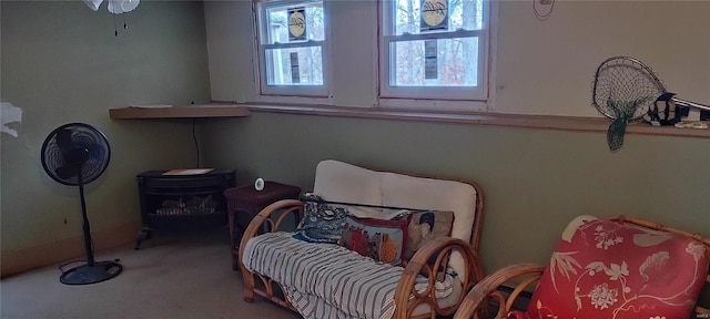 sitting room with ceiling fan and light colored carpet