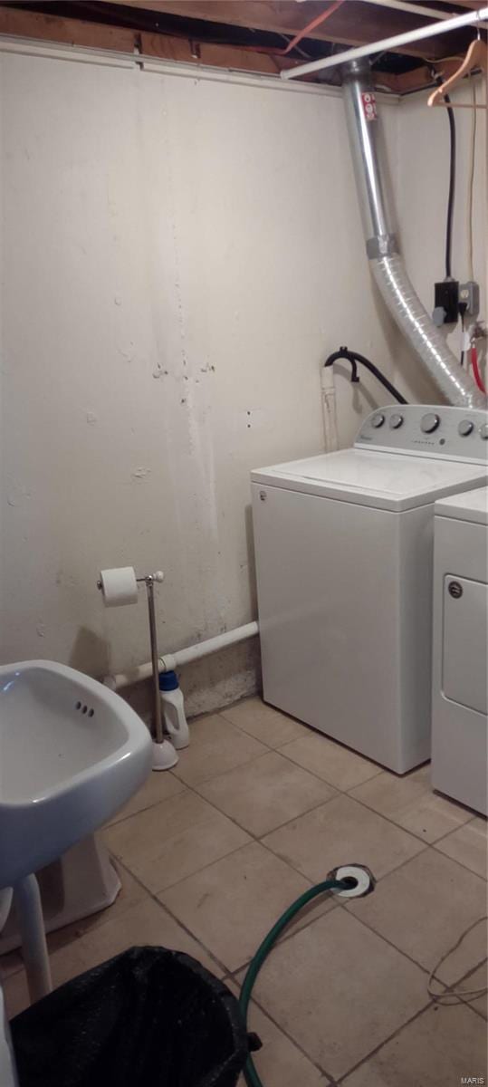 laundry area with separate washer and dryer and light tile floors