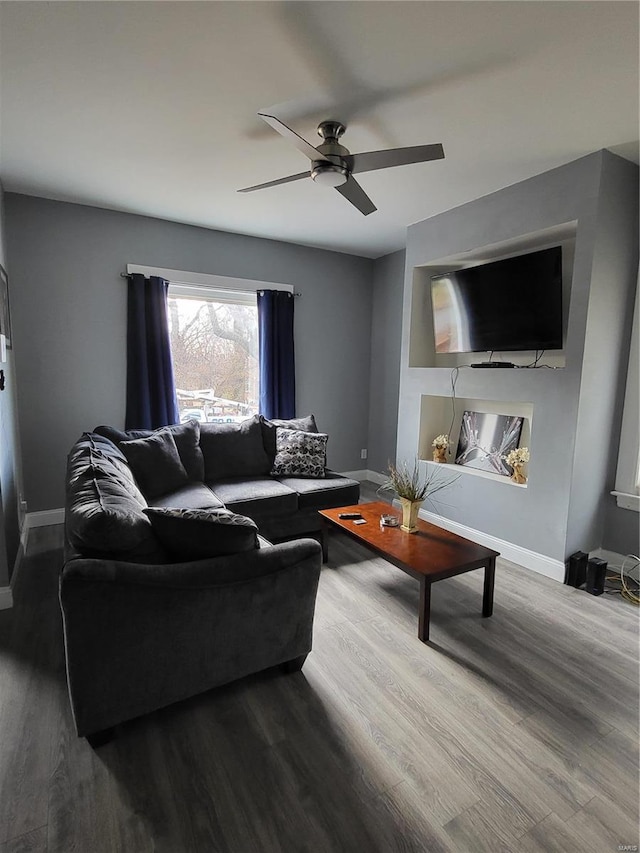 living room with ceiling fan and dark hardwood / wood-style floors