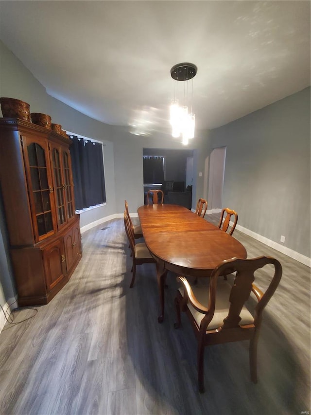 dining space with an inviting chandelier and hardwood / wood-style floors