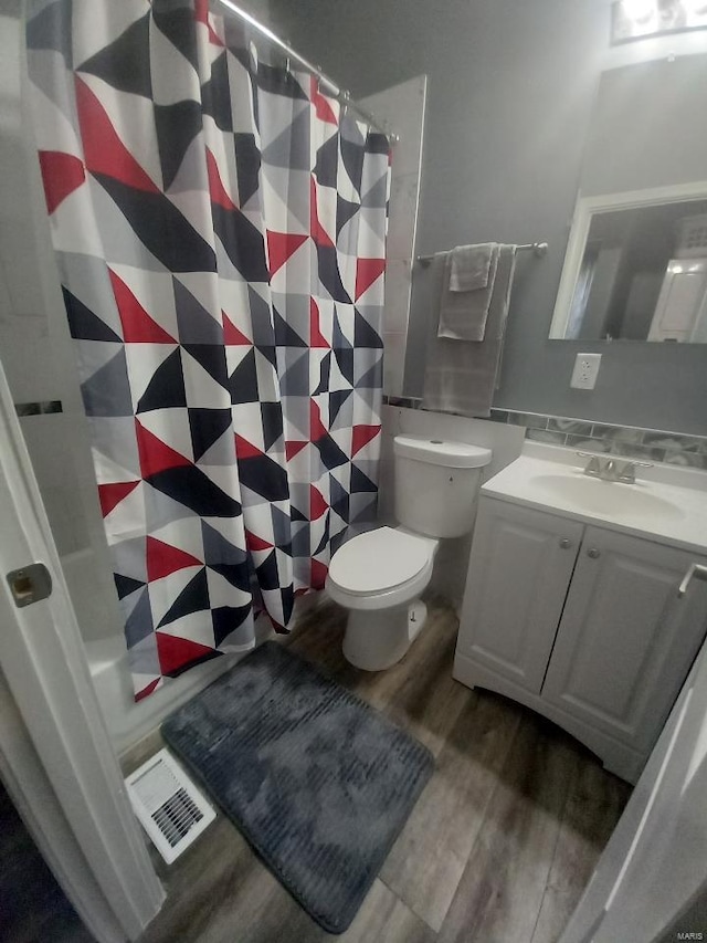 bathroom featuring hardwood / wood-style floors, vanity, toilet, and a shower with shower curtain