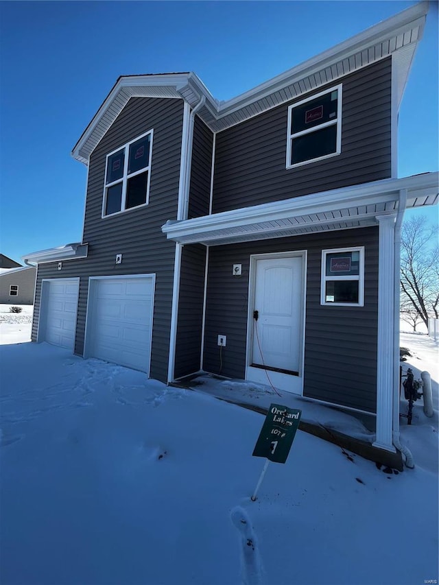 front facade with a garage