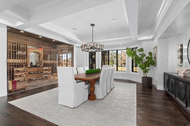 dining room featuring dark wood-type flooring, an inviting chandelier, beam ceiling, and coffered ceiling