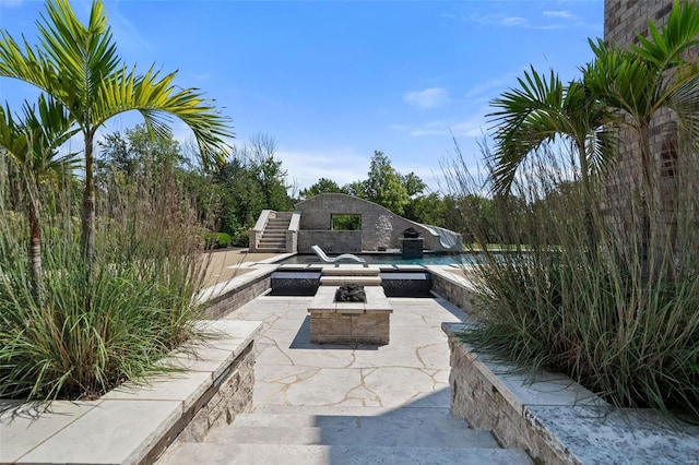 view of patio / terrace with an outdoor fire pit