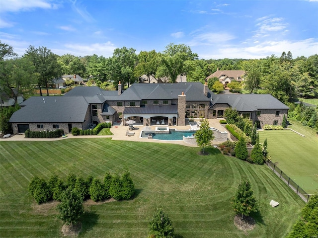 back of property featuring a lawn and a patio