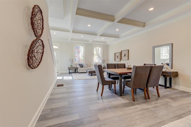 dining area featuring coffered ceiling, beam ceiling, light hardwood / wood-style floors, and crown molding