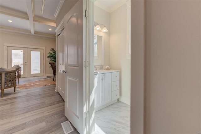 bathroom featuring french doors, hardwood / wood-style flooring, beam ceiling, coffered ceiling, and vanity