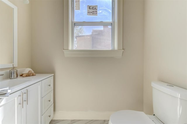 bathroom with tile floors, toilet, and vanity