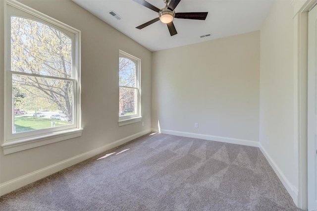 empty room with ceiling fan and carpet floors