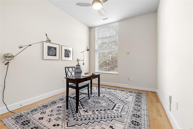 home office with wood-type flooring and ceiling fan