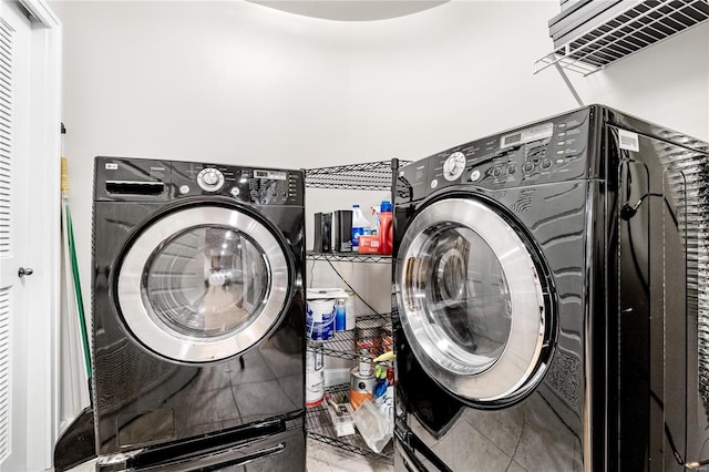 clothes washing area featuring washer and clothes dryer