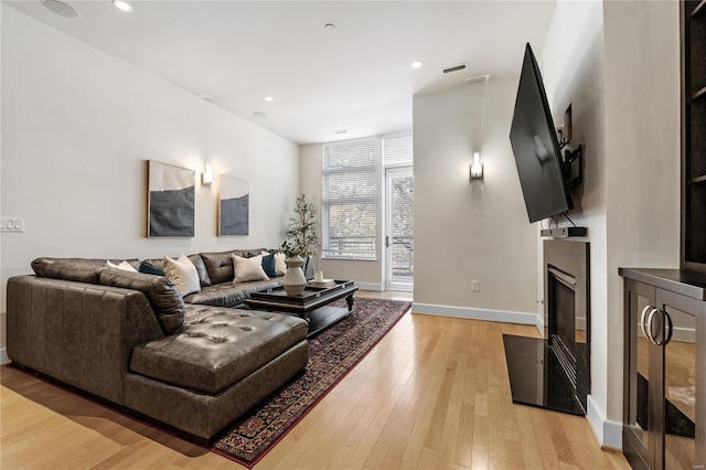 living room with light hardwood / wood-style flooring