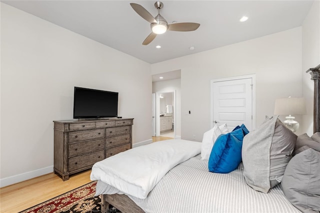 bedroom with ceiling fan, light hardwood / wood-style floors, and ensuite bathroom