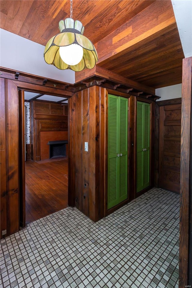 interior space with wood ceiling and wood walls