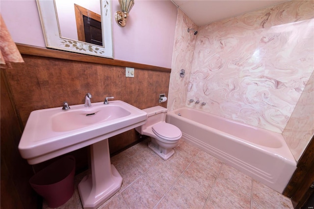 bathroom with tile patterned floors, shower / bathtub combination, and toilet