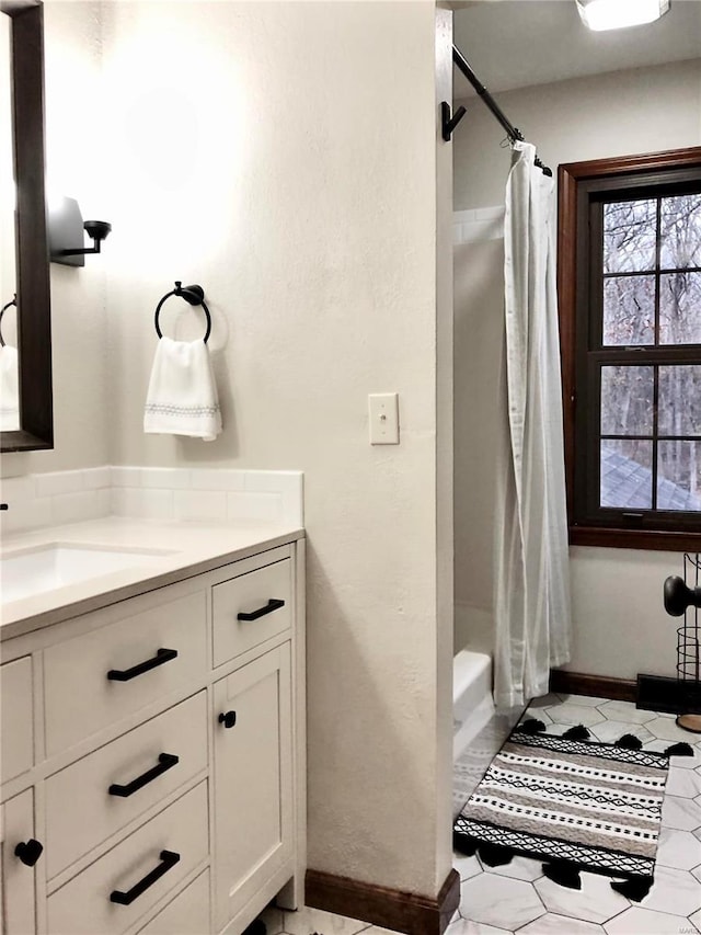 bathroom with vanity and shower / bath combo with shower curtain