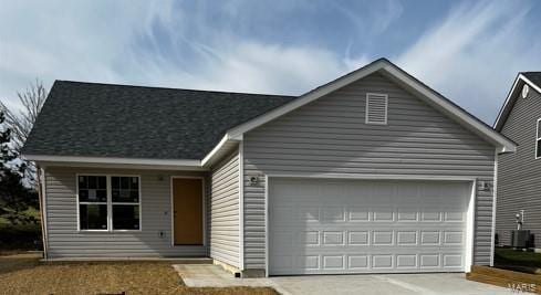 ranch-style home with central AC unit and a garage