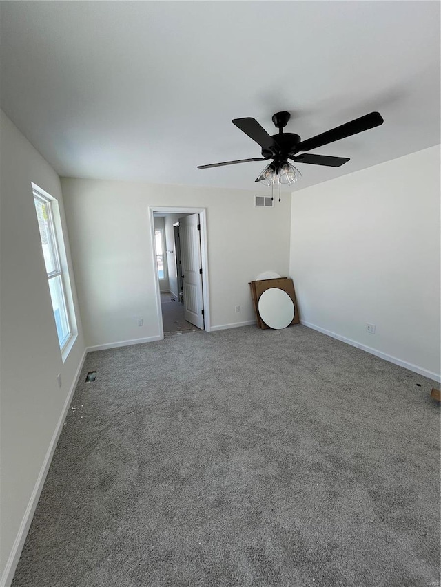 unfurnished bedroom featuring ceiling fan and carpet