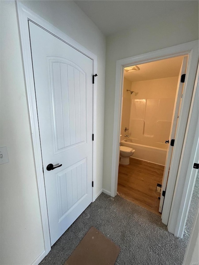 bathroom with shower / bathtub combination and toilet