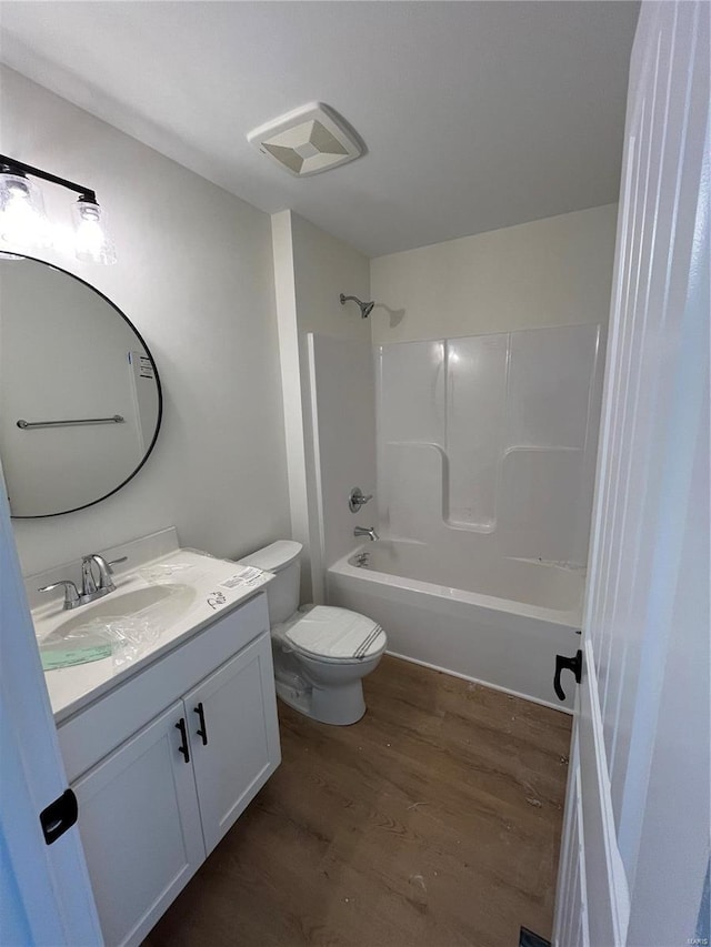 full bathroom with shower / bathing tub combination, vanity, toilet, and wood-type flooring