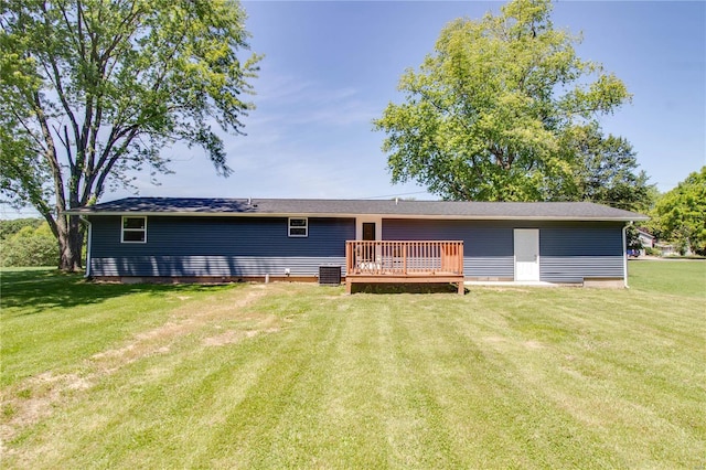 rear view of property featuring central AC, a yard, and a deck