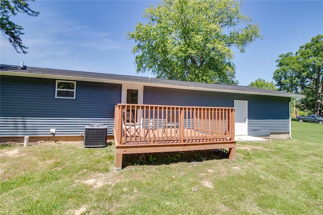 back of house featuring a deck, a yard, and central air condition unit