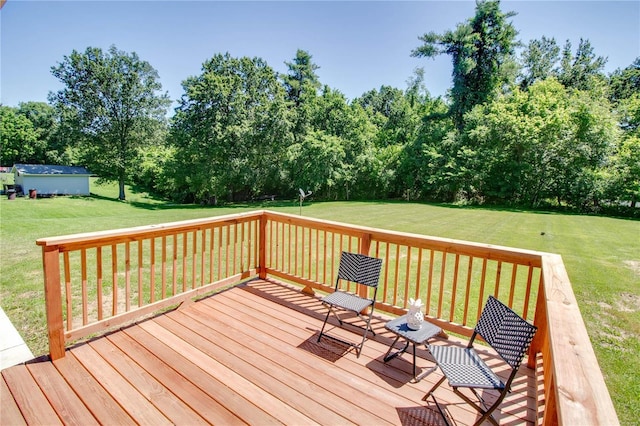 wooden terrace featuring a yard