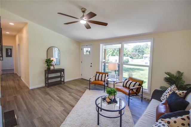 living room featuring wood-type flooring, ceiling fan, and lofted ceiling