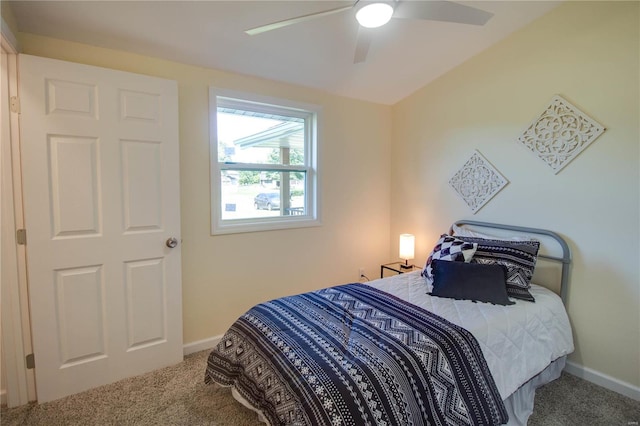 carpeted bedroom with ceiling fan and lofted ceiling