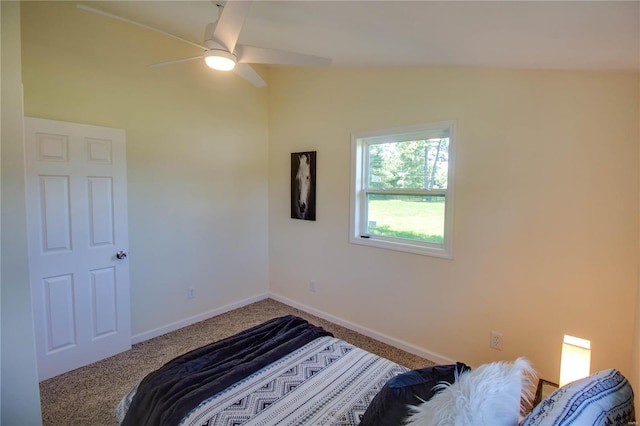 carpeted bedroom with ceiling fan and vaulted ceiling